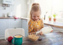 Girl_Pouring_Milk_On_Cheerios