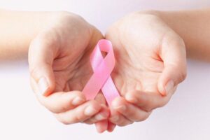 Hands Holding Pink Ribbon