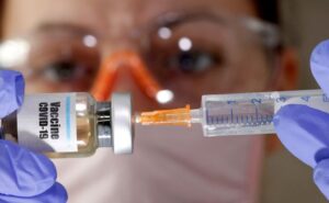Syringe and COVID Vax
