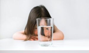 Girl Looking Through Glass