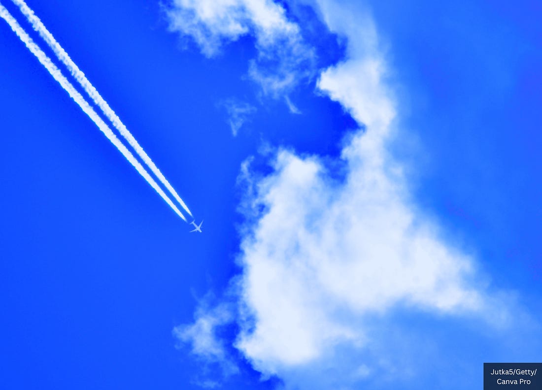 Plane Leaving Contrail On Blue Sky