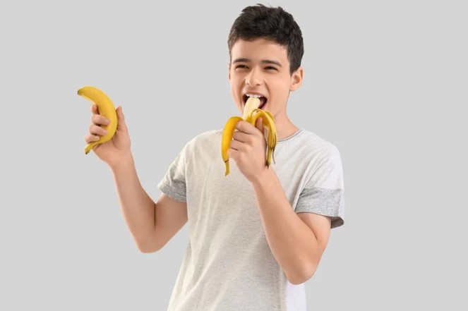 Teen Eating A Banana
